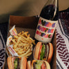 Bottle of Catch & Release Wines Anyone Anytime Anyplace red blend, with in-and-out burgers and fries