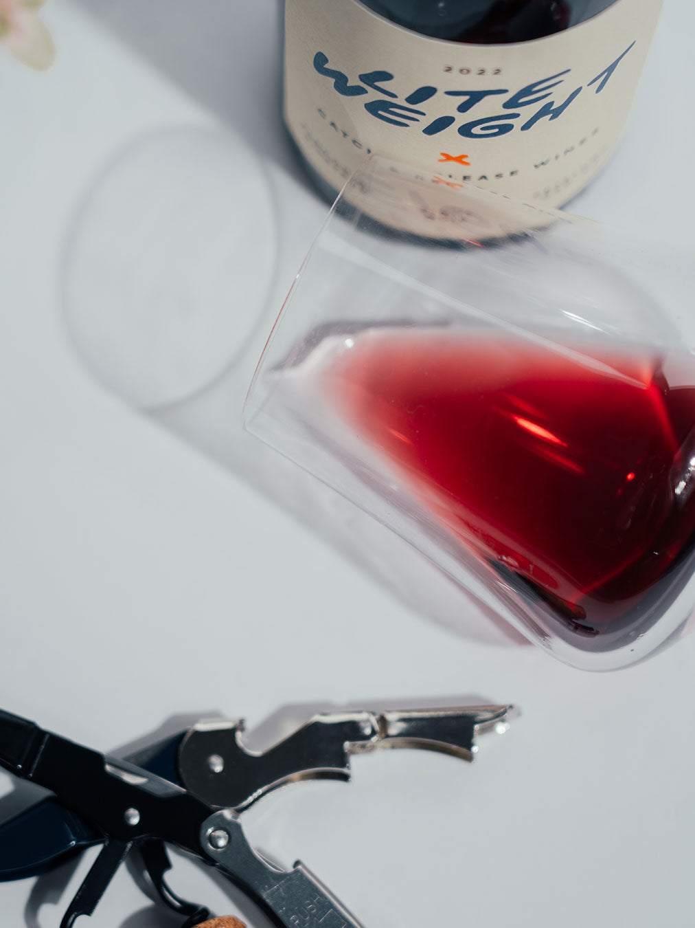 Catch & Release Wines 2022 Lite Weight wine color in glass next to bottle