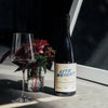 Catch & Release Wines 2022 Lite Weight on concrete with flowers and poured glass