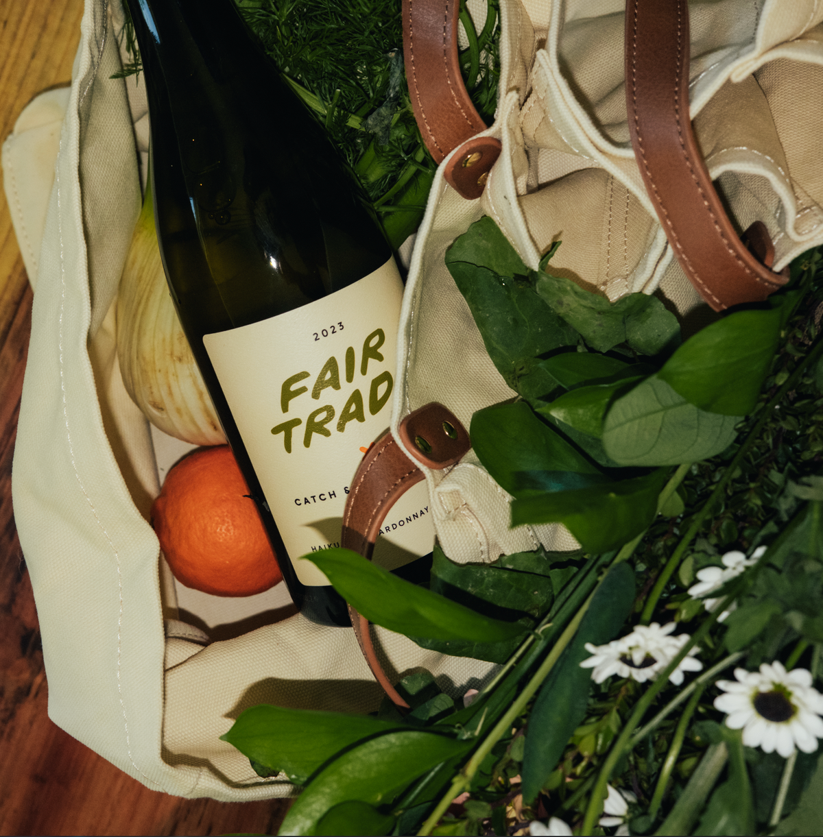 2023 Fair Trade Chardonnay bottle among flowers and produce