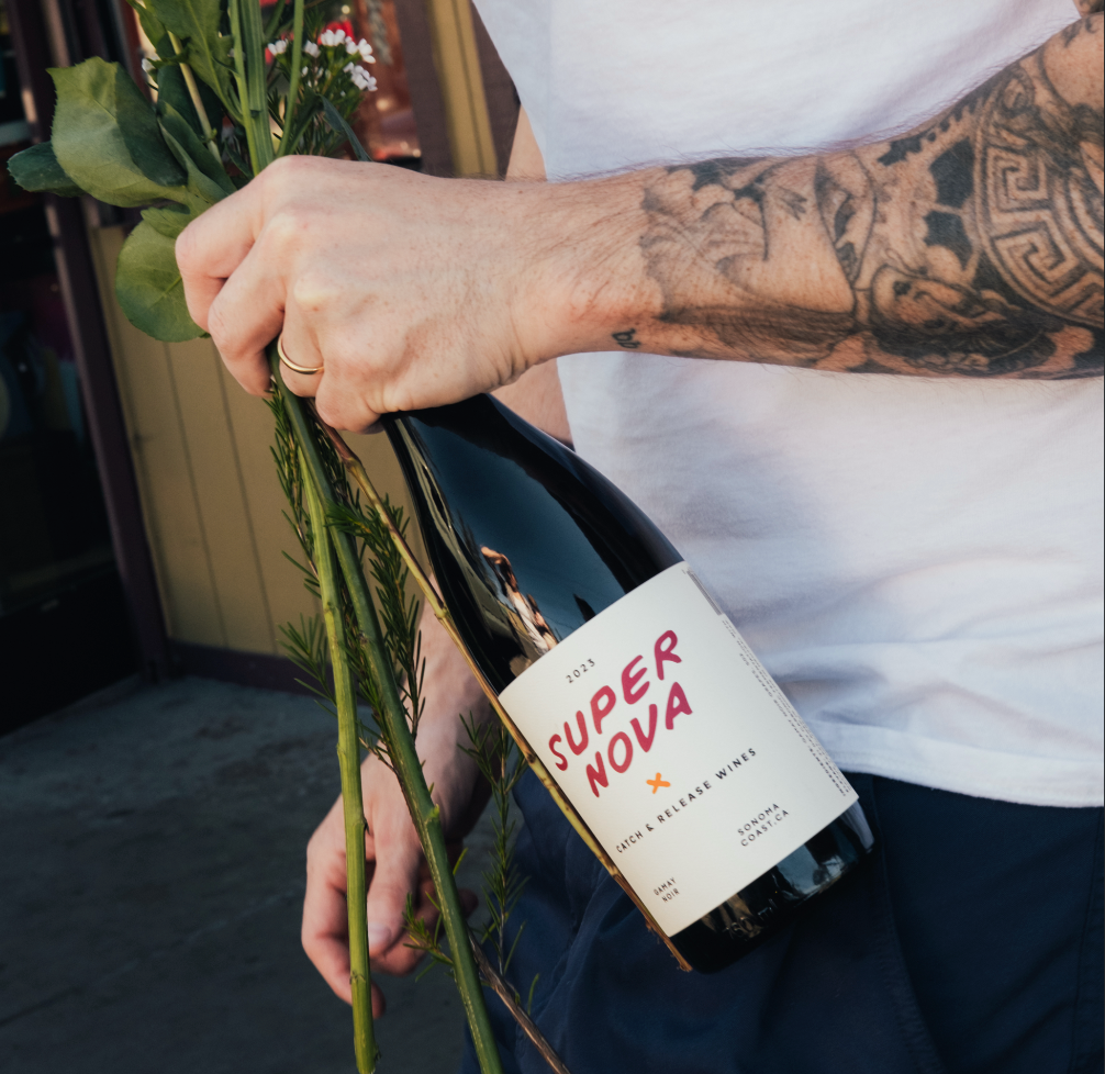 Person holding a bottle of 2024 Supernova Gamay