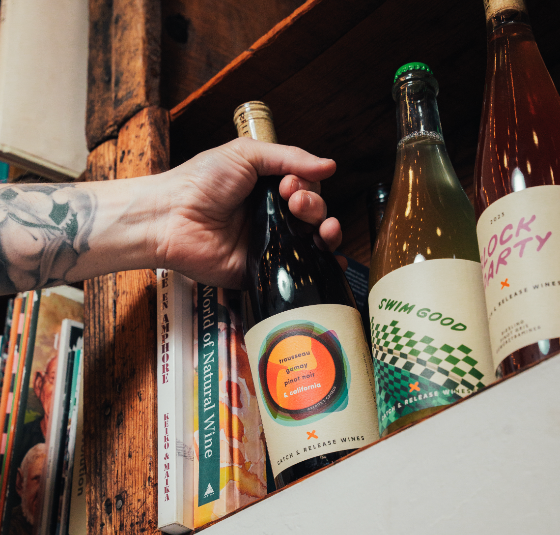 Catch & Release wine bottles on a bookshelf